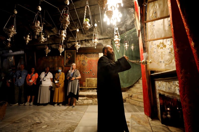 FILE PHOTO: Foreign tourists visit the church of Nativity in Bethlehem, as the coronavirus disease (COVID-19) restrictions ease