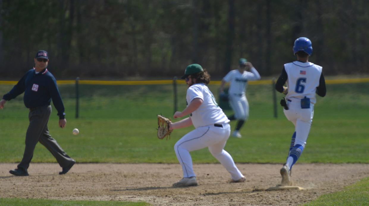 Mashpee's Preston Joia, right, comes into first base as D-Y's Alex Finn readies for the ball during a first inning play.