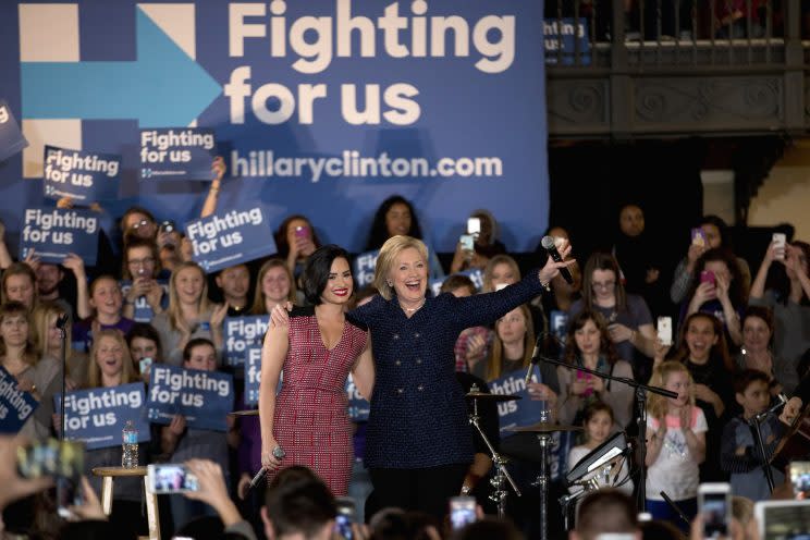 Hillary Clinton and musician Demi Lovato acknowledge the cheering crowd at a rally on the campus of University of Iowa in Iowa City, Iowa. (Photo: Jae C. Hong/AP)