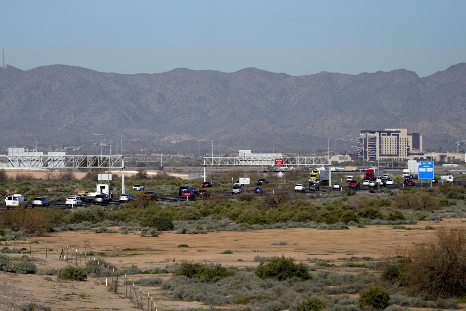 Traffic moves along the notoriously congested stretch of I-10 through tribal land called the Wild Horse Pass Corridor, with the Wild Horse Pass Casino shown at right, Wednesday, Jan. 25, 2023 in Chandler, Ariz. With the Gila River Indian Community's backing, Arizona allocated or raised about $600 million of a nearly $1 billion plan that would widen the most bottleneck-inducing, 26-mile section of I-10 on the route between Phoenix and Tucson. But its request for federal money to finish the job fell short — a victim of the highly competitive battle for transportation grants under the new infrastructure law. (AP Photo/Matt York)