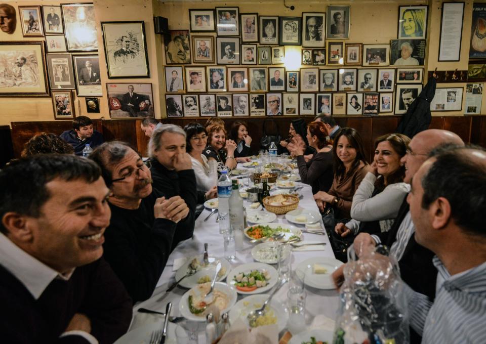 FILE - In this March 16, 2013 file photo, Turks enjoy a dinner with raki, a traditional Turkish aniseed-based alcoholic drink, at Yakup Restaurant in Istanbul, Turkey. A look at legislation passed in Turkey's parliament early Friday May 24 2013 that would ban all alcohol advertising and tighten restrictions on the sale of such beverages, and how such a law could affect tourists and liquor companies in the mainly Muslim but secular country.(AP Photo/File)