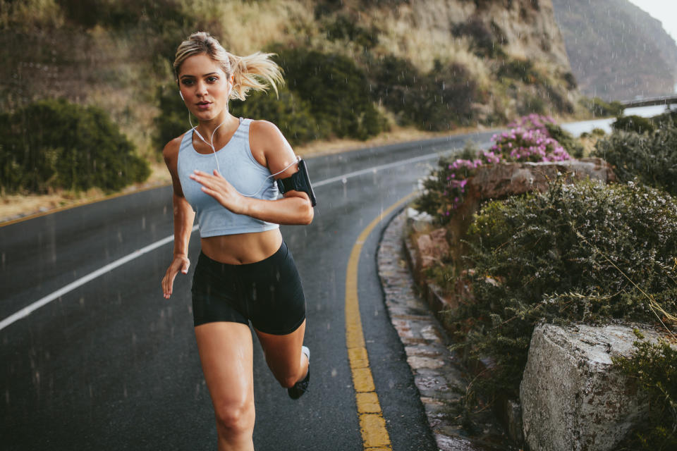 a female runner running on a road