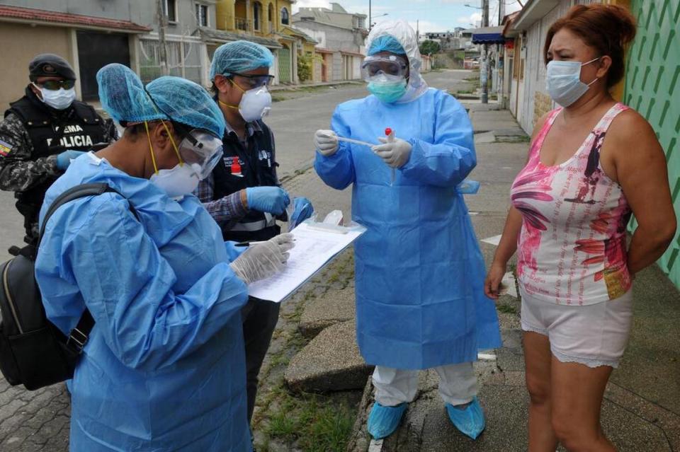 Health Ministry personnel test a woman for COVID-19 in the Samanes 7 residential complex in northern Guayaquil, Ecuador, on April 19, 2020. Guayaquil, Ecuador’s largest city, has been hit hard by the coronavirus pandemic.