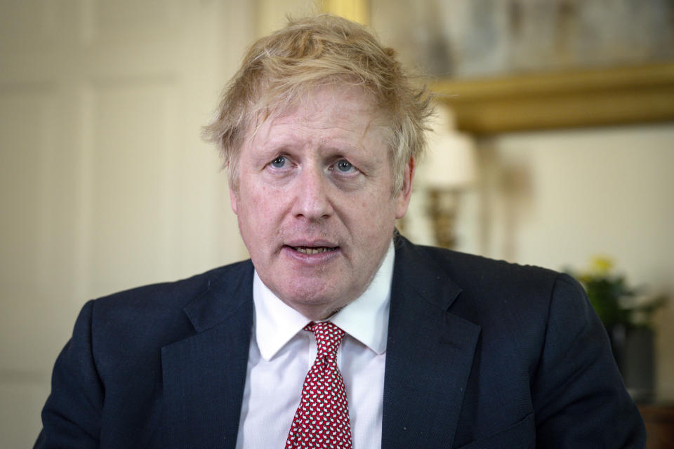 In this handout photo issued by 10 Downing Street, Britain's Prime Minister Boris Johnson speaks from 10 Downing Street praising NHS staff in a video message, after he was discharged from hospital a week after being admitted with persistent coronavirus symptoms, in London, Sunday, April 12, 2020. British Prime Minister Boris Johnson is praising the National Health Service staff for saving his life in a video on Twitter after his discharge from St. Thomas’ Hospital in London. He said he did not have the words to properly thank the staff at NHS for “saving my life.” He lauded two nurses Johnson said stood by his bedside for 48 hours “when things could have gone either way.” (Pippa Fowles/10 Downing Street via AP)