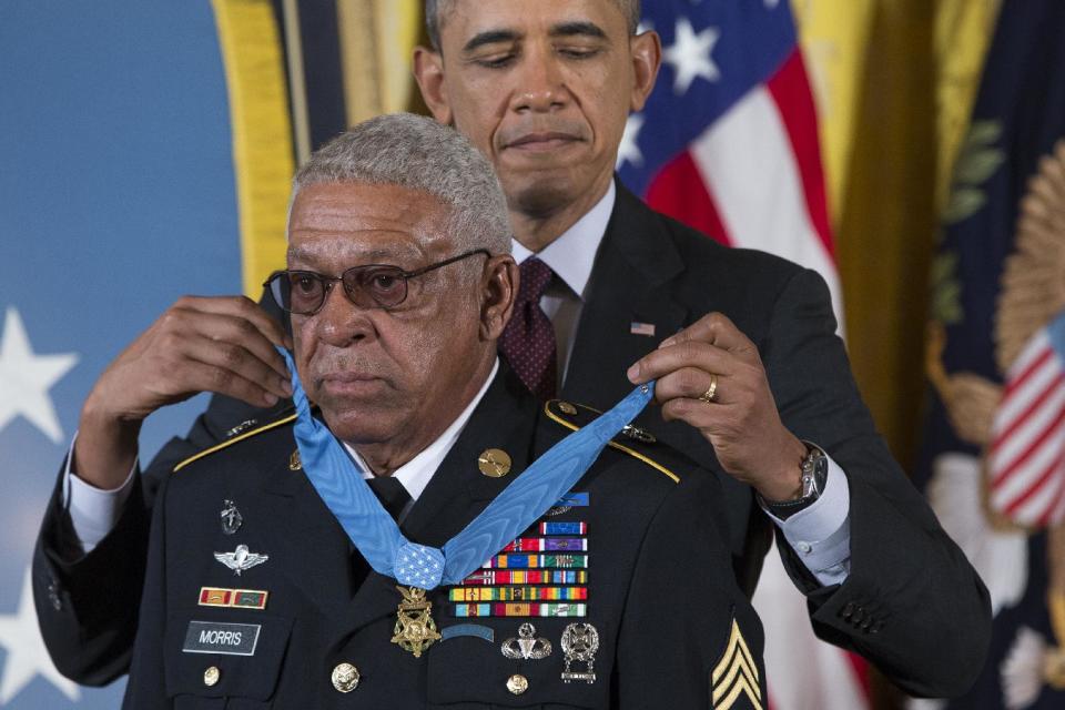 Staff Sgt. Melvin Morris is awarded the Medal of Honor by President Barack Obama during a ceremony in the East Room of the White House in Washington, Tuesday, March 18, 2014. President Obama awarded 24 Army veterans the Medal of Honor for conspicuous gallantry in recognition of their valor during major combat operations in World War II, the Korean War and the Vietnam War. (AP Photo/ Evan Vucci)