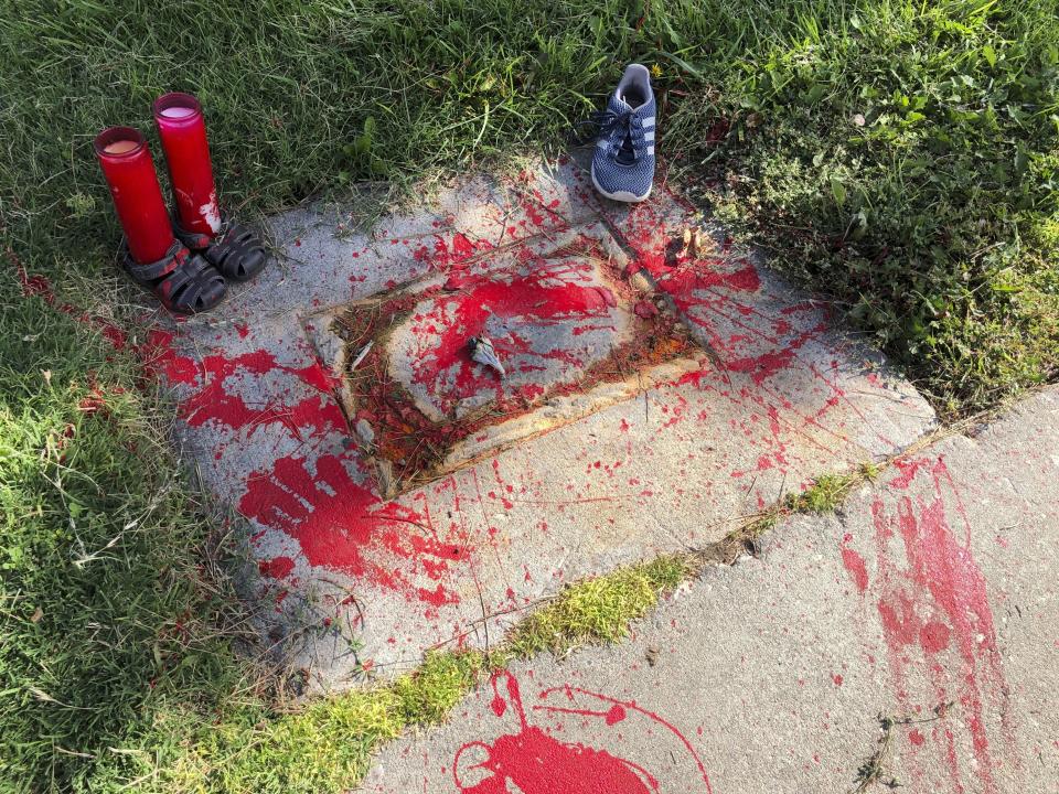 FILE - Red painted handprints cover the empty spot at a park in Albuquerque, New Mexico, on Thursday, July 1, 2021, where a historical marker for the Indigenous children who died while attending a boarding school nearby was removed. The U.S. Interior Department is expected to release a report Wednesday, May 11, 2022, that it says will begin to uncover the truth about the federal government's past oversight of Native American boarding schools. (AP Photo/Susan Montoya Bryan,File)