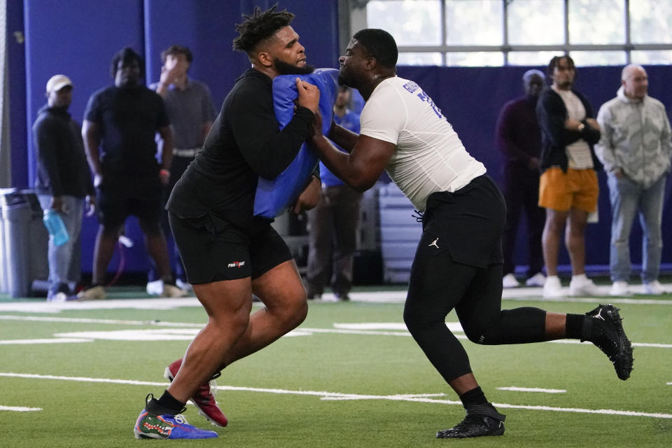 Florida offensive linemen O'Cyrus Torrence, left, and Richard Gouraige performs a drill during an NFL football Pro Day, Thursday, March 30, 2023, in Gainesville, Fla. (AP Photo/John Raoux)