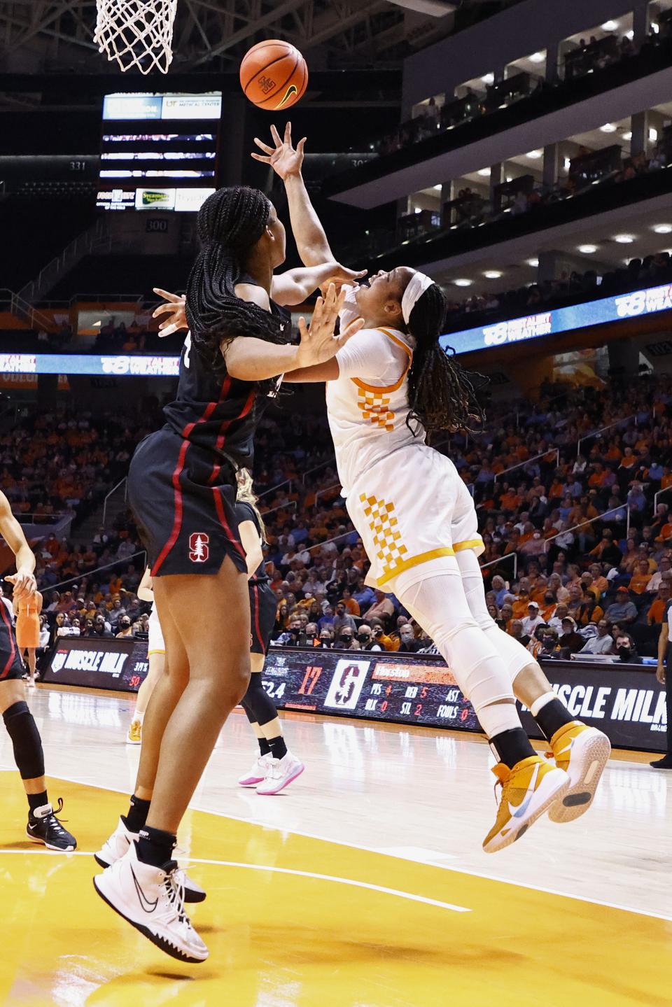 Tennessee guard Sara Puckett, right, shoots past Stanford forward Kiki Iriafen, left, during the first half of an NCAA college basketball game Saturday, Dec. 18, 2021, in Knoxville, Tenn. (AP Photo/Wade Payne)