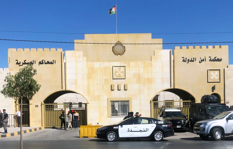 A police vehicle is parked outside a military court in Amman