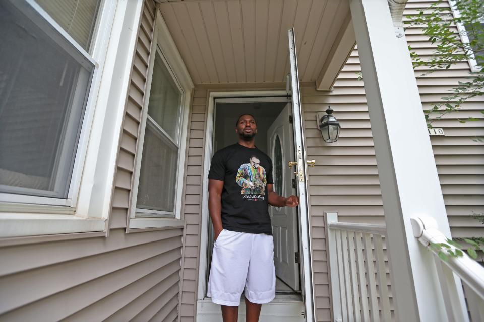 Marlin Dixon stands in the doorway of his apartment in Menomonee Falls on the one-year anniversary of his release. Dixon said the neighborhood is quiet and good for his mental health.