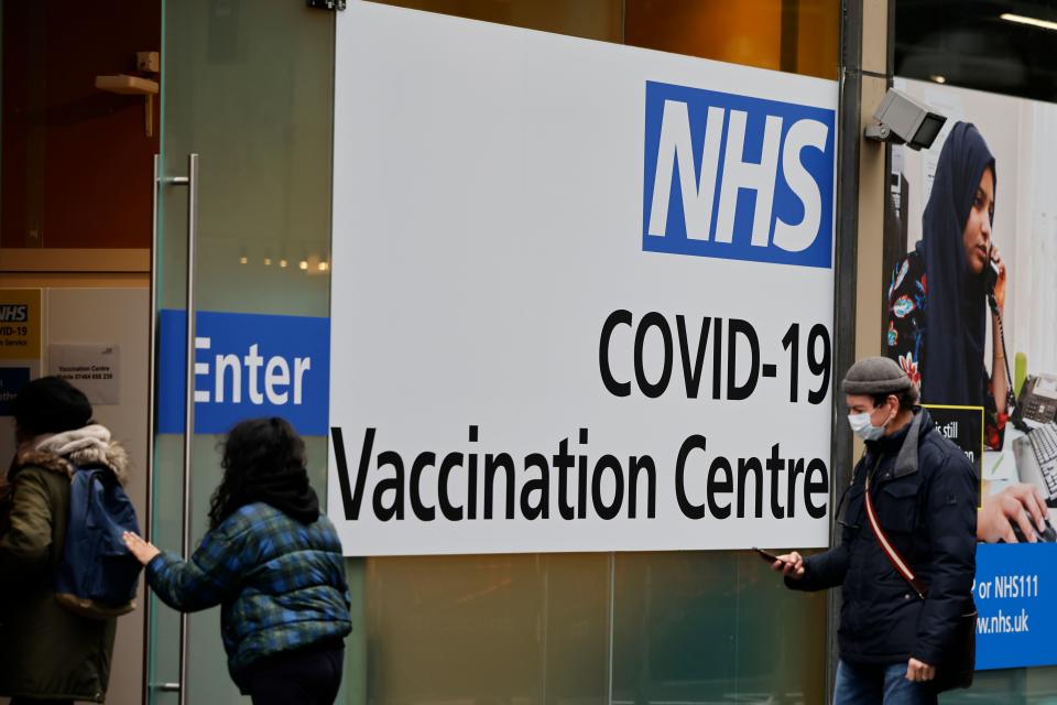 People queue to enter the NHS Covid-19 vaccination centre in Westfield Stratford City shopping centre in east London on February 15, 2021 as Britain's largest ever vaccination programme continues. - Prime Minister Boris Johnson called Britain hitting a target of inoculating 15 million of the most vulnerable people with a first coronavirus jab 