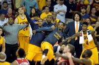 Cleveland Cavaliers center Tristan Thompson (13), guard J.R. Smith (5), forward LeBron James (23) and guard Iman Shumpert (4) react from the bench during the fourth quarter against the Atlanta Hawks in game four of the Eastern Conference Finals of the NBA Playoffs at Quicken Loans Arena. Mandatory Credit: David Richard-USA TODAY Sports