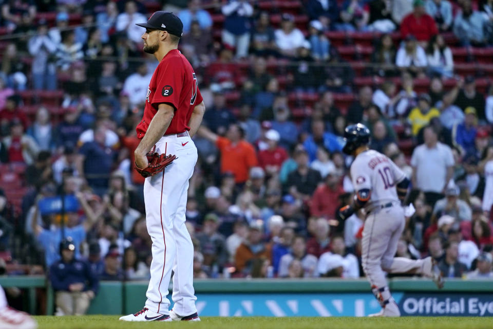 Boston Red Sox starting pitcher Nathan Eovaldi, left, waits for Houston Astros' Yuli Gurriel (10) to run the bases on a two-run home run during the second inning of a baseball game at Fenway Park, Tuesday, May 17, 2022, in Boston. Eovaldi gave up five home runs in the second inning. (AP Photo/Charles Krupa)