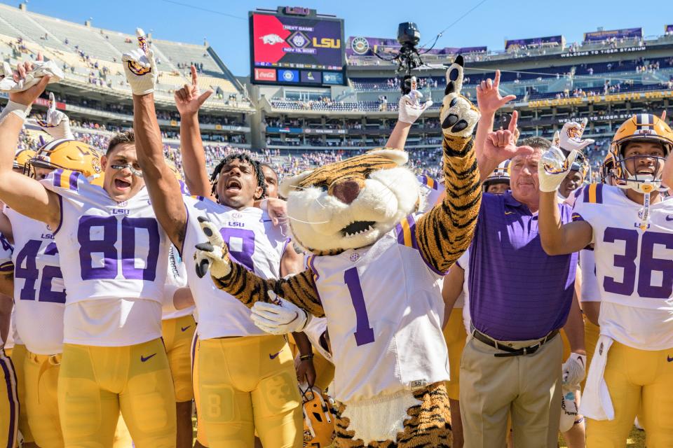 LSU head coach Ed Orgeron and the team celebrate their win against Florida.