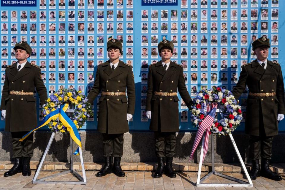 Ukrainian honor guards stand in font of the Wall of Remembrance for the Deceased for Ukraine as U.S. President visits Ukrainian President for a meeting in Kyiv on Feb. 20, 2023.<span class="copyright">DIMITAR DILKOFF—AFP via Getty Images</span>