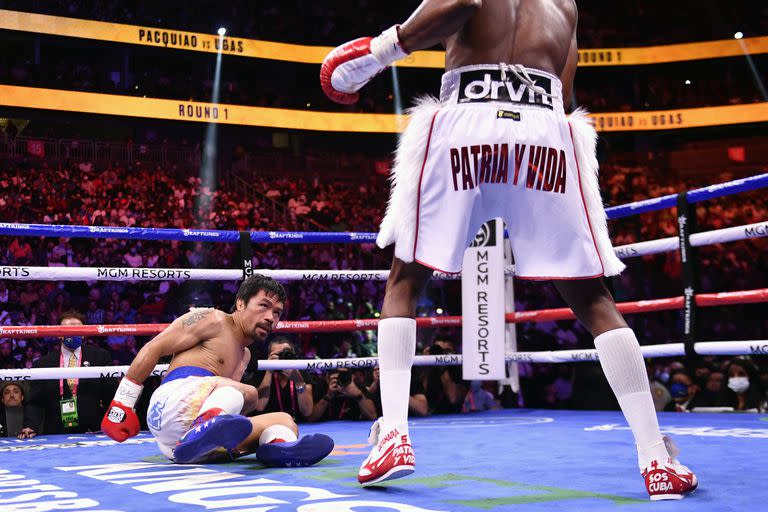 Manny Pacquiao mira a Yordenis Ugas después de ser derribado durante el combate de boxeo por el Campeonato de Peso Welter de la AMB 