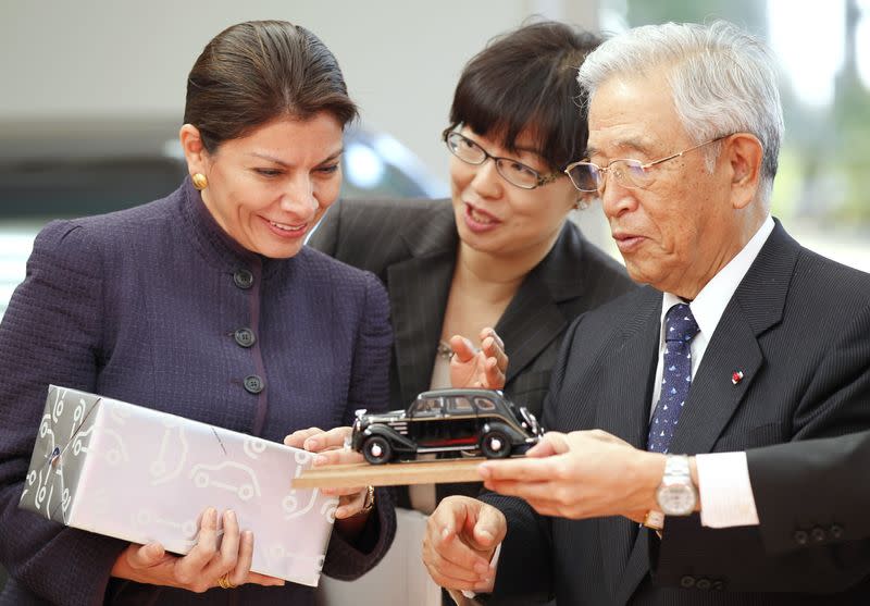 Costa Rica's President Chinchilla receives a souvenir from Toyota Motor Corp's Honorary Chairman Toyoda in Toyota, central Japan