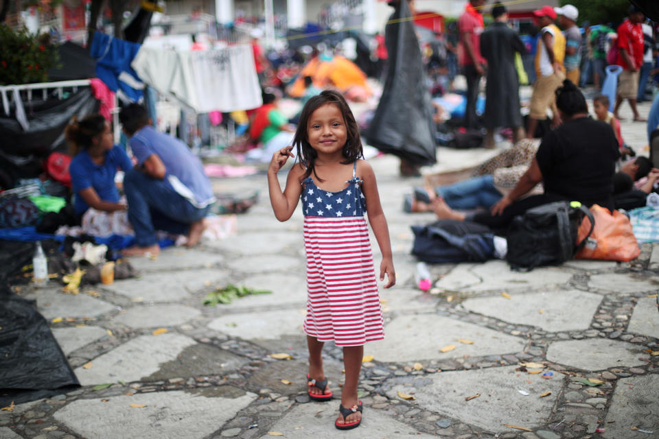 <p>Chelsy Montserrat Maldonado, a 4-year-old migrant girl from Honduras who is part of a caravan of thousands from Central America en route to the U.S., wears a U.S. flag-themed dress in a makeshift camp as they take rest in Tapanatepec, Mexico, Oct. 28, 2018. (Photo: Hannah McKay/Reuters) </p>