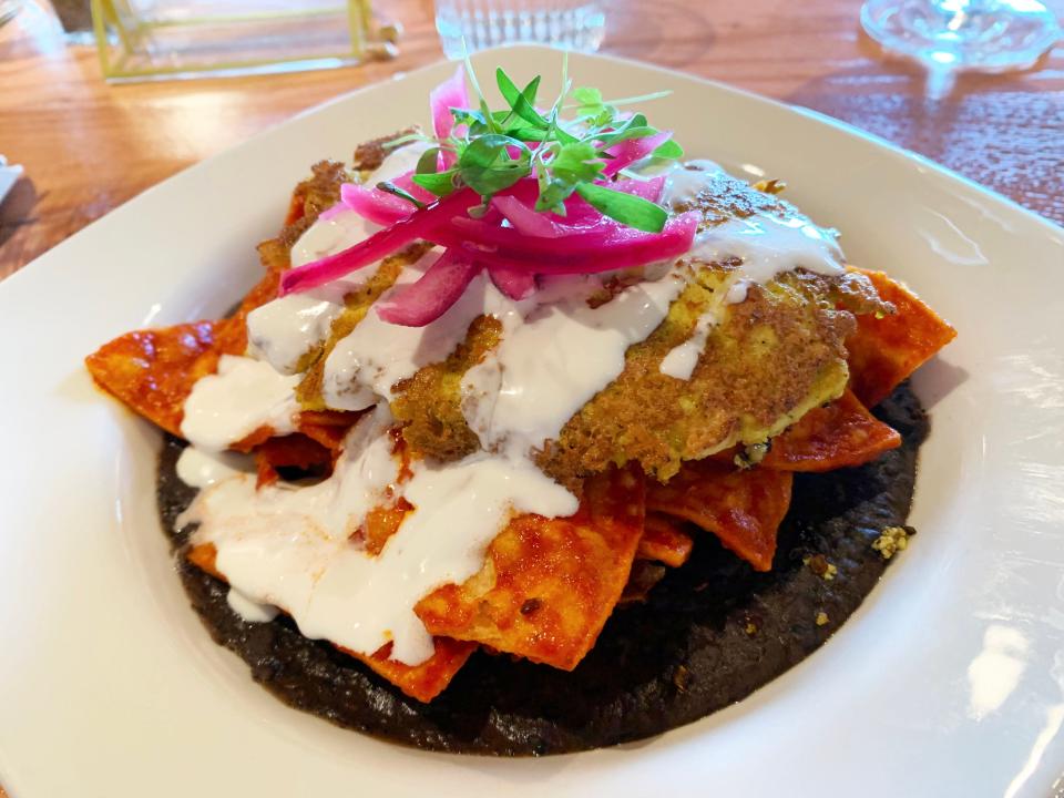 Vegan chilaquiles at The Coronado come on refried black beans with a tofu scramble.