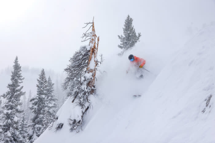 A skier rides over steep terrain in Crested Butte