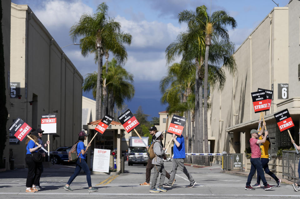 Members of the Writers Guild of America picket outside an entrance to Warner Bros. Studios, Tuesday, May 2, 2023, in Burbank, Calif. The first Hollywood strike in 15 years began Tuesday as the economic pressures of the streaming era prompted unionized TV and film writers to picket for better pay outside major studios, a work stoppage that already is leading most late-night shows to air reruns. (AP Photo/Chris Pizzello)