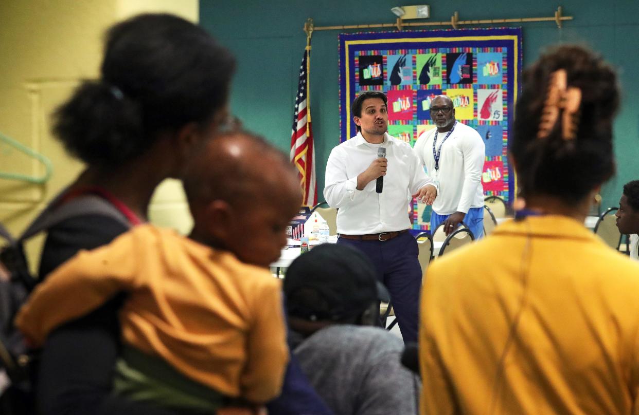 Mayor Shammas Malik, center, provides an update to the residents who were forced out of their homes by a chemical fire on Rosemary Boulevard at an evacuation center at Firestone Park Community Center, Thursday, Sept. 5, 2024, in Akron, Ohio.