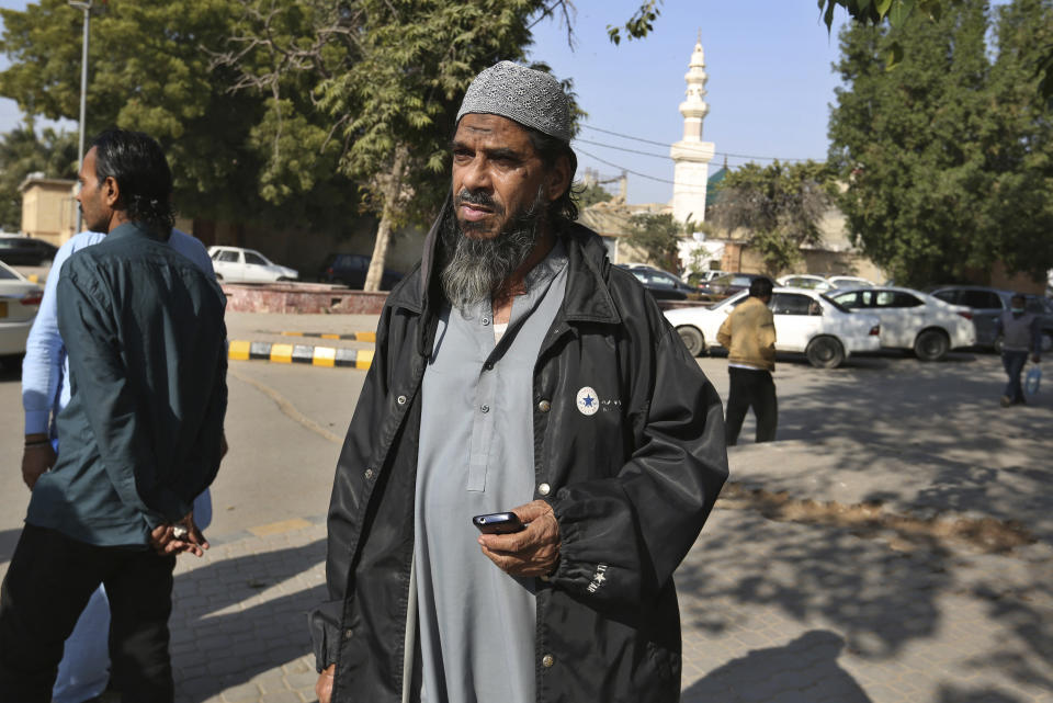 Sheikh Muhammad Aslam, brother of British-born Pakistani Ahmed Omar Saeed Sheikh, who is charged in the 2002 murder of American journalist Daniel Pearl, leaves the Sindh High Court, in Karachi, Pakistan, Thursday, Dec. 24, 2020. The provincial court overturned a Supreme Court Decision that Ahmed Omar Saeed Sheikh should remain in custody during an appeal of his acquittal on charges he murdered Pearl. (AP Photo/Fareed Khan)