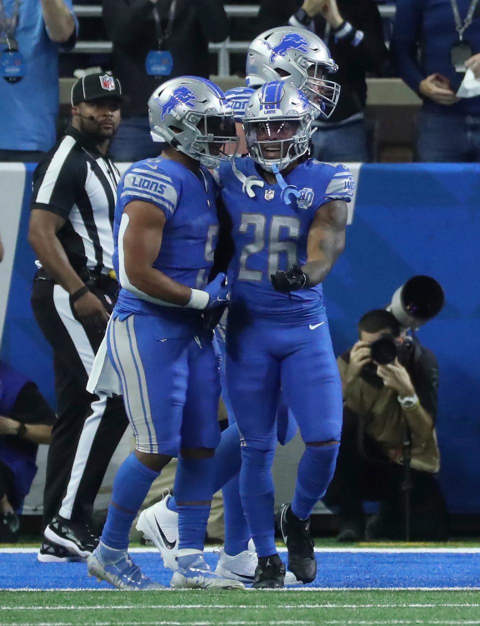 Detroit Lions running backs David Montgomery, left, and Jahmyr Gibbs celebrate a Gibbs touchdown during the first half at Ford Field, Sunday, Nov. 19, 2023.