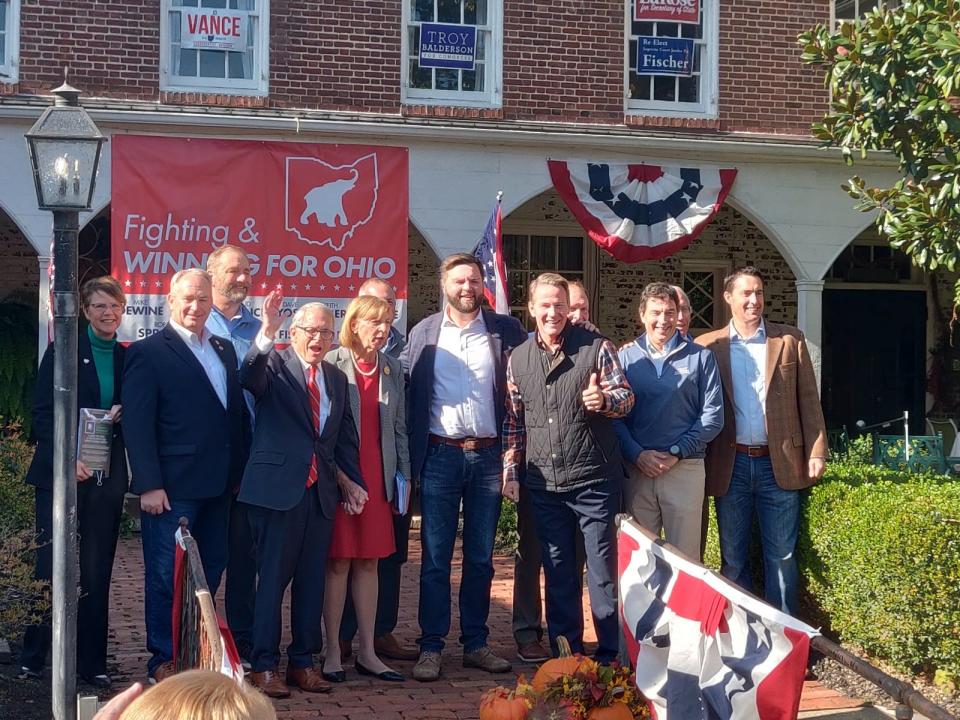 J.D. Vance poses with all the Ohio Republicans on the ballot next week during a midterms bus tour stop in Zanesville, Ohio.