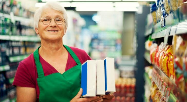 Senior woman working in a grocery store