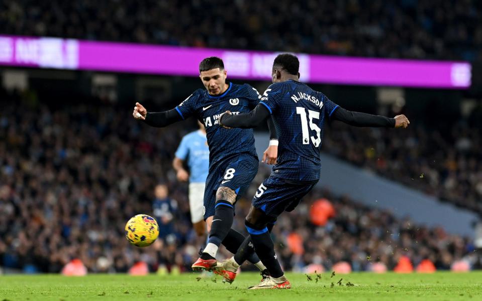 Enzo Fernandez and Nicolas Jackson of Chelsea try to shoot at the same time during the Premier League match between Manchester City and Chelsea at the Etihad