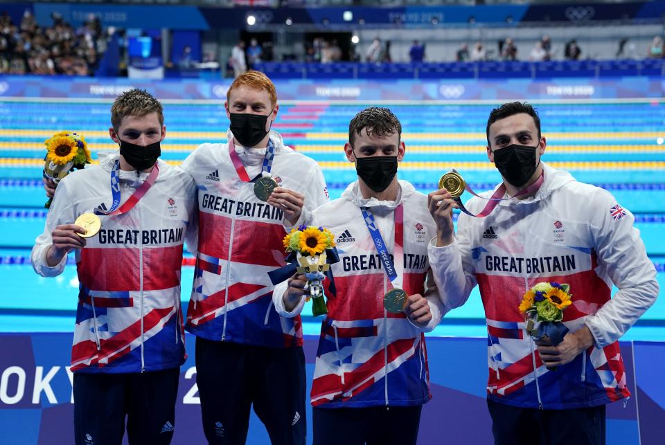 Great Britain’s Duncan Scott, Tom Dean, Matthew Richards and James Guy celebrate gold in the Men’s 4×200 freestyle relay (Adam Davy/PA) ( )