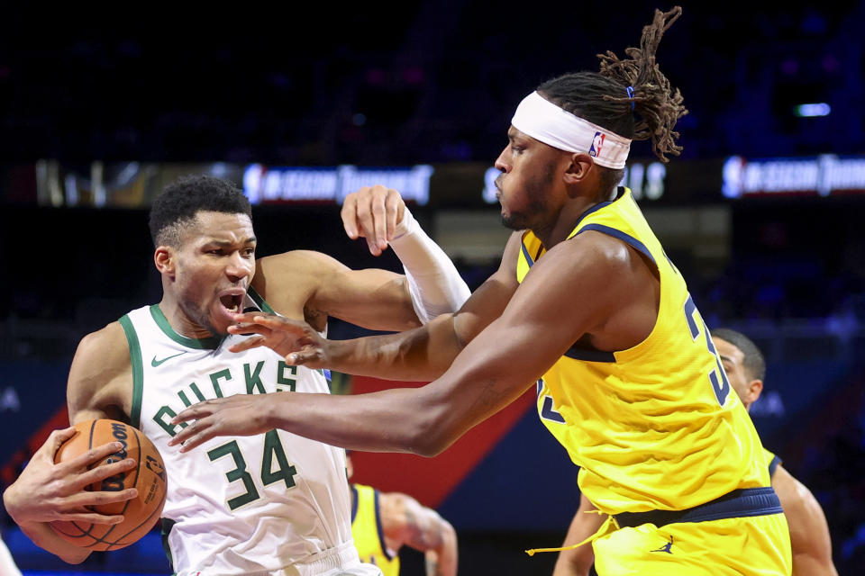 Milwaukee Bucks forward Giannis Antetokounmpo (34) reacts while Indiana Pacers center Myles Turner, front right, defends during the first half of a semifinal game in the NBA basketball In-Season Tournament, Thursday, Dec. 7, 2023, in Las Vegas. (AP Photo/Ian Maule)