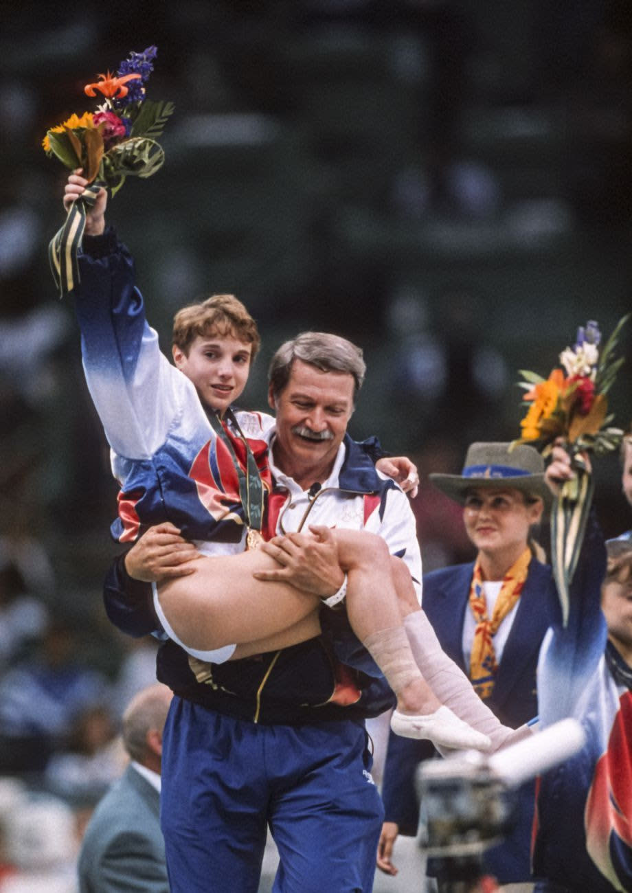 Strug is carried by coach Béla Károlyi. (David Madison/Getty Images)