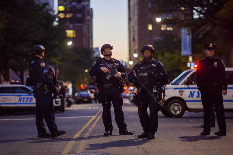 <em>Heavily armed police stand guard near the scene as New York comes to terms with another attack in the city (AP)</em>