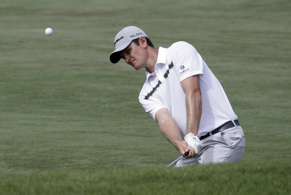 Justin Rose of England, chips from the fairway to the 11th green from during the third round of The Players championship golf tournament at TPC Sawgrass, Saturday, May 10, 2014, in Ponte Vedra Beach, Fla. (AP Photo/John Raoux)