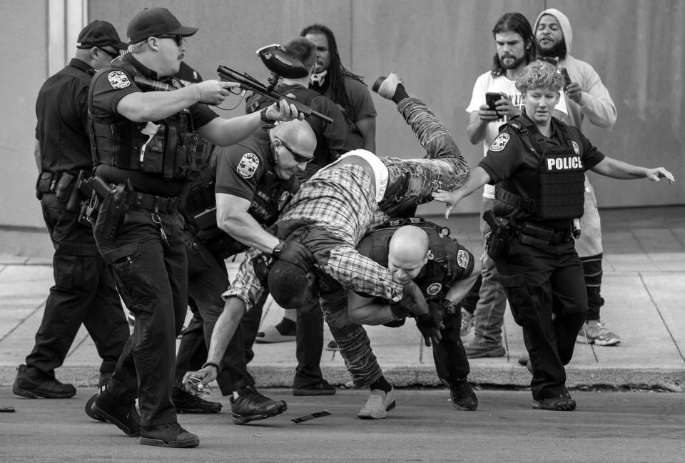 A man is flipped by Louisville Metro police officers and arrested for refusing to leave Jefferson Street during a morning of protests over the shooting death of Breonna Taylor by the police. June 17, 2020