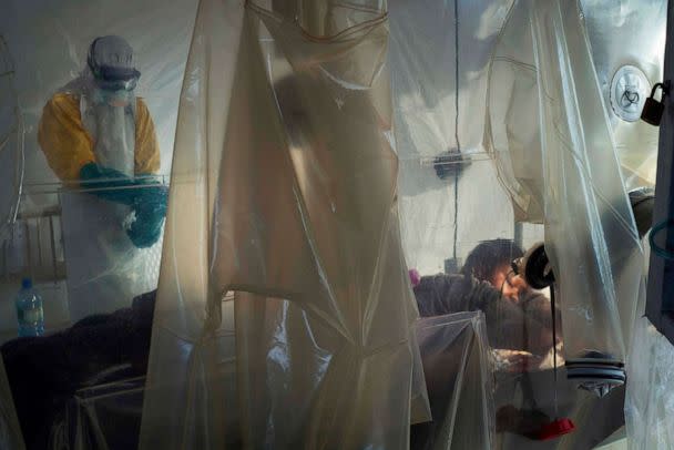 PHOTO: A health worker wearing protective gear checks on a patient isolated in a plastic cube at an Ebola treatment center in Beni, Congo, July 13, 2019. (Jerome Delay/AP, FILE)