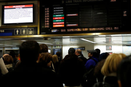 People stand in Pennsylvania Station waiting for trains in the Manhattan borough of New York City, New York, U.S., March 16, 2018. REUTERS/Shannon Stapleton