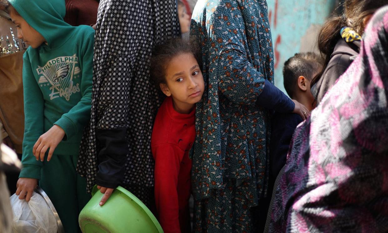 <span>Palestinians queue for food at a charity kitchen in Rafah on 5 February.</span><span>Photograph: Ibraheem Abu Mustafa/Reuters</span>