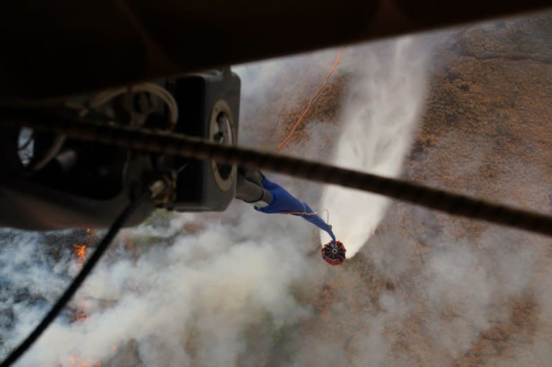 Hawaii Army National Guard CH47 Chinooks perform aerial water bucket drops on Maui to fight wildfires on the island Wednesday. Photo by MSgt. Andrew Jackson/USAF/U.S. National Guard