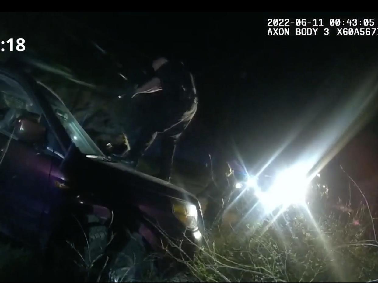 Screenshot from bodycam video released by the lawyers of Christian Glass' family shows officers surrounding Glass' car, breaking his window and tasing him before he was shot and killed on June 11.