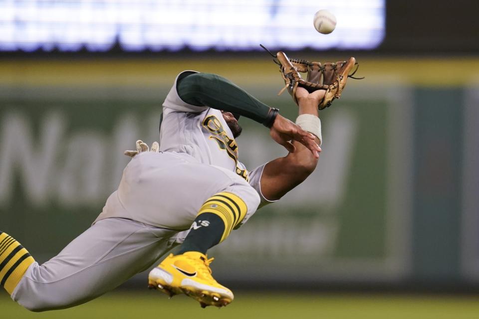 Oakland Athletics second baseman Tony Kemp (5) dives to catch a fly ball hit by Los Angeles Angels' Livan Soto during the eighth inning of a baseball game in Anaheim, Calif., Tuesday, Sept. 27, 2022. (AP Photo/Ashley Landis)