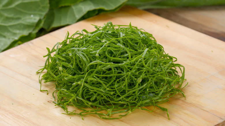 Chiffonade greens on cutting board