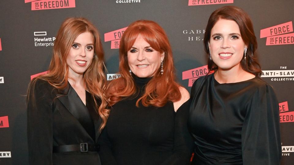 Princess Beatrice standing with Sarah Ferguson and Princess Eugenie