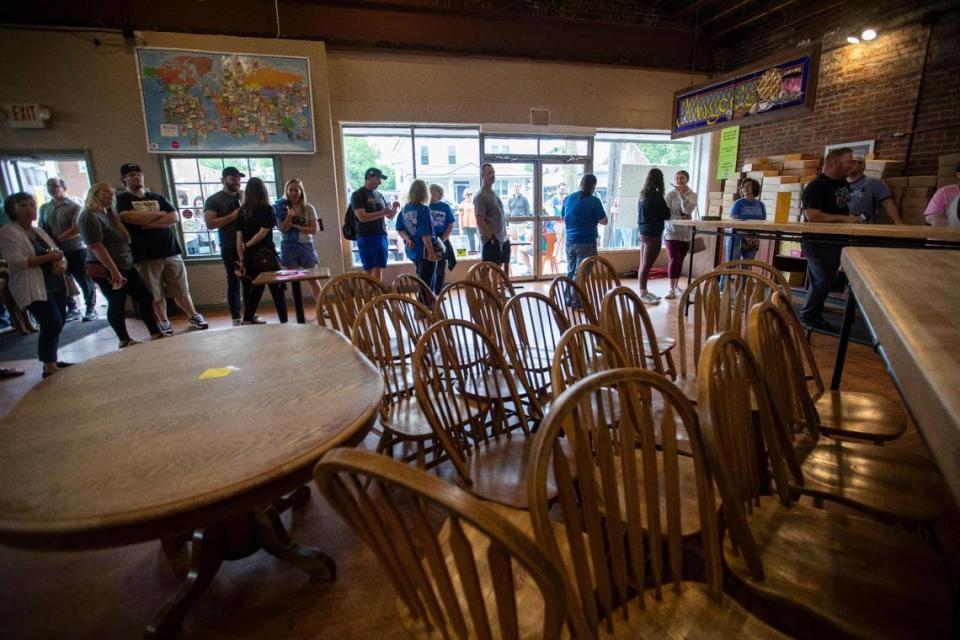 Patrons gather and line up around the corner of South Ashland and Main Street to try and purchase something on the last day of business for Magee’s Bakery in Lexington, Ky., Saturday, May 13, 2023. Some people waited in line over two hours.