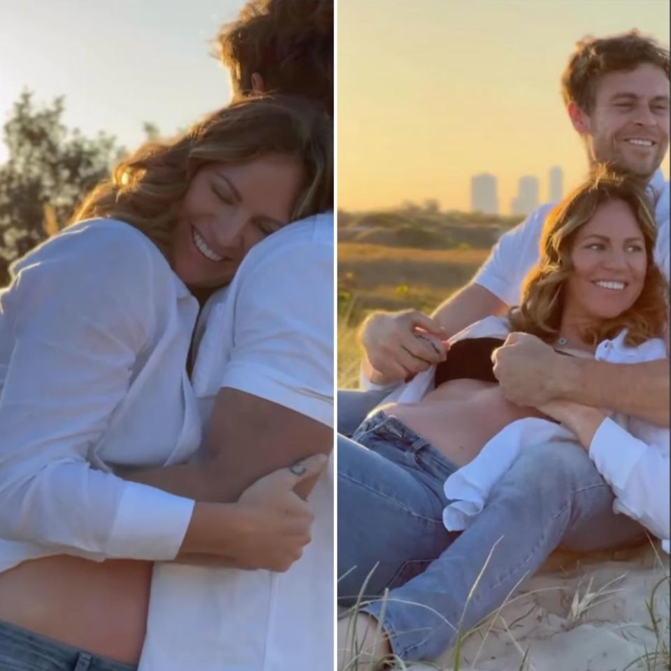 Ryan Gallagher and Emily Seebohm smiling while posing in front of the sunrise