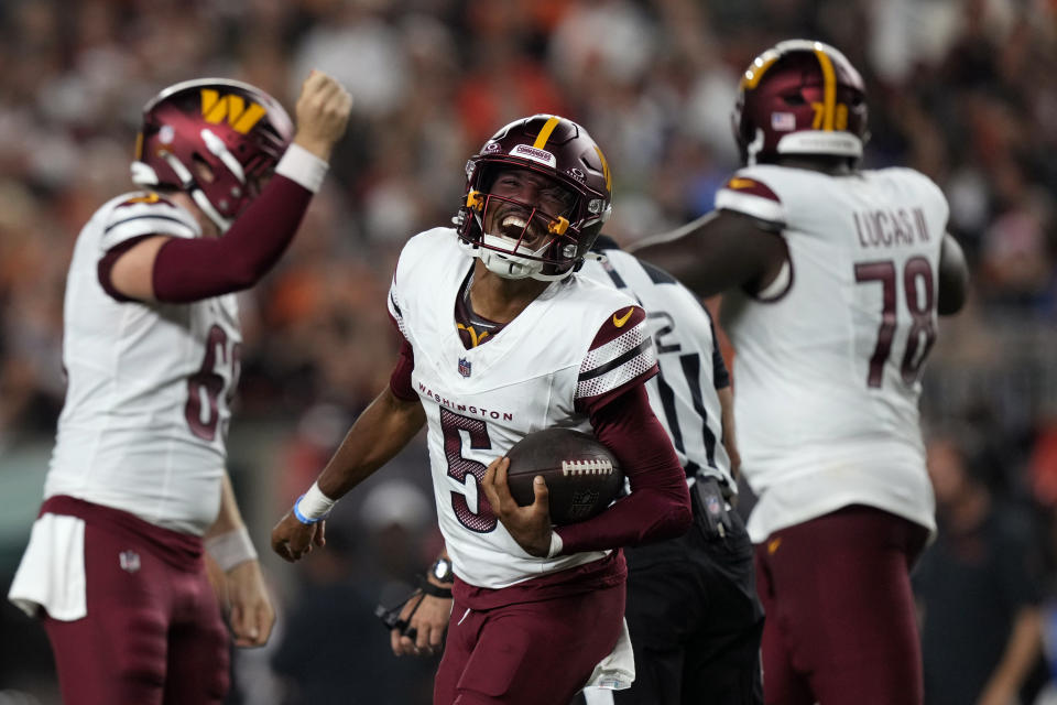 Washington Commanders quarterback Jayden Daniels (5) celebrates after throwing a touchdown pass during the second half of an NFL football game against the Cincinnati Bengals, Monday, Sept. 23, 2024, in Cincinnati. (AP Photo/Carolyn Kaster)