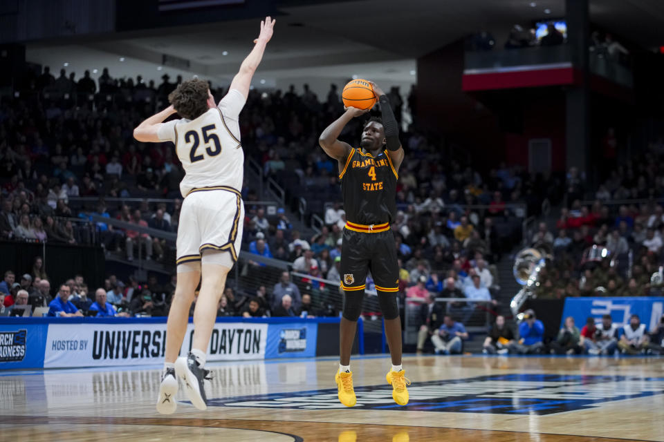 Grambling State forward Antwan Burnett, right, attempts a 3-point shot against Montana State forward Sam Lecholat during the first half of a First Four game in the NCAA men's college basketball tournament Wednesday, March 20, 2024, in Dayton, Ohio. (AP Photo/Aaron Doster)
