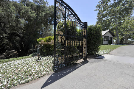 A bronze statue stands next to a gate in Michael Jackson's Neverland Ranch in Los Olivos, California July 3, 2009. REUTERS/Phil Klein/Files